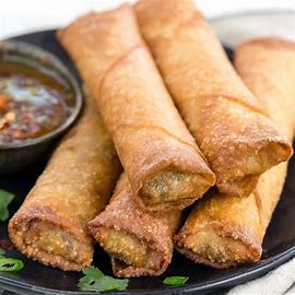 An egg roll is a popular fried appetizer commonly served in Chinese-American restaurants. It features a thick, crispy wheat flour skin filled with a savory mix of shredded cabbage, pork, and other ingredients. The filling often includes a combination of meat and vegetables, making it a delicious and versatile dish.